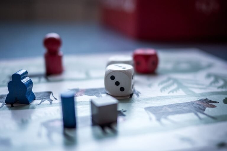 Dice and wooden game pieces on a board