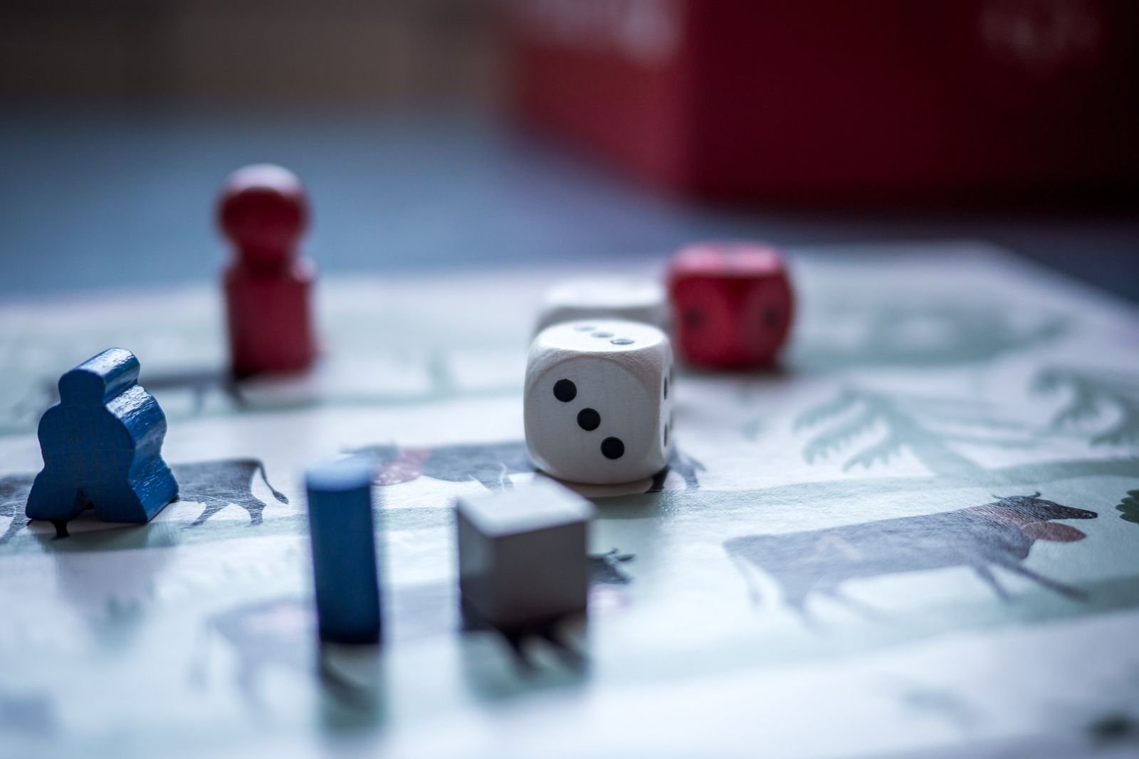 Dice and wooden game pieces on a board
