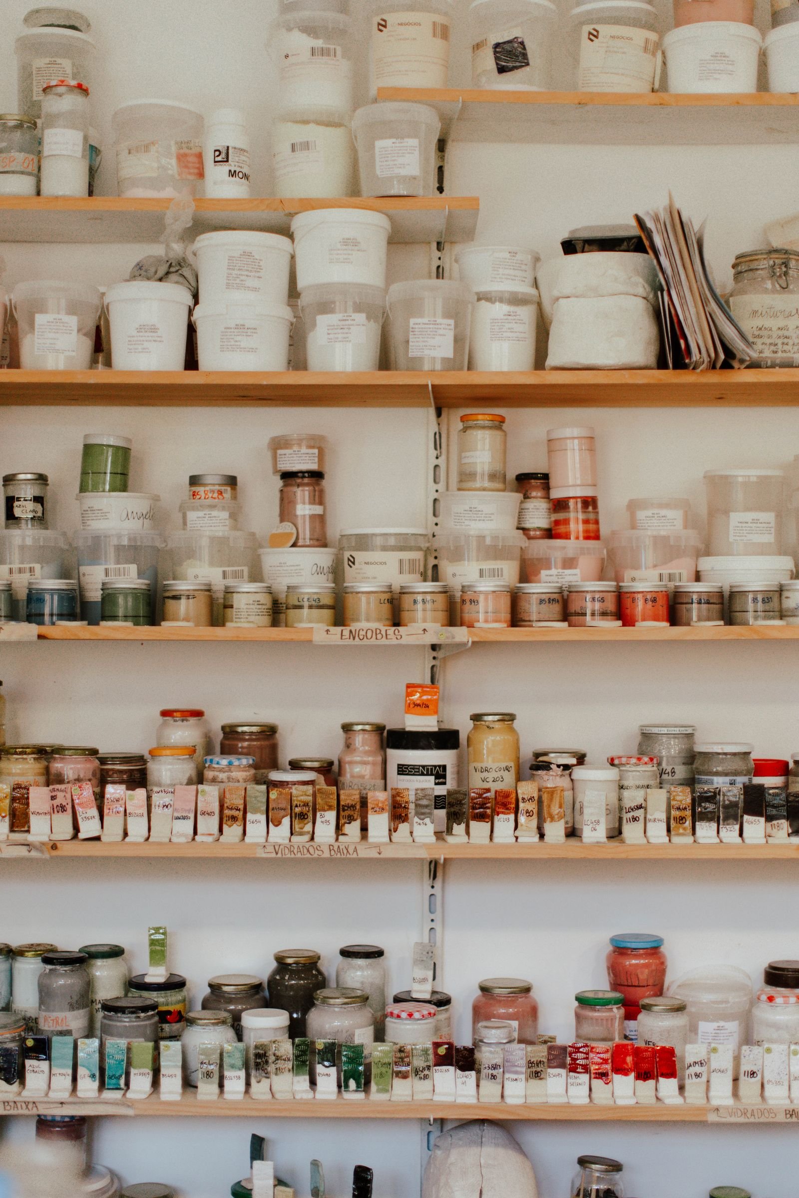 Neatly organized hobby supplies on wooden shelves
