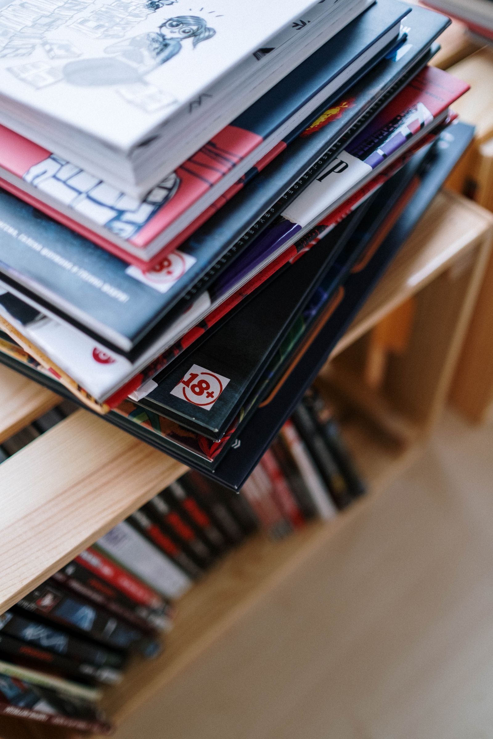 Stack of colorful comic books on a bookshelf
