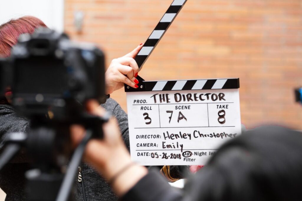 Close-up of a film clapperboard held in front of a camera filming a take on set
