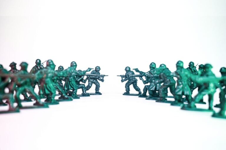 Green toy soldiers facing off on a white background