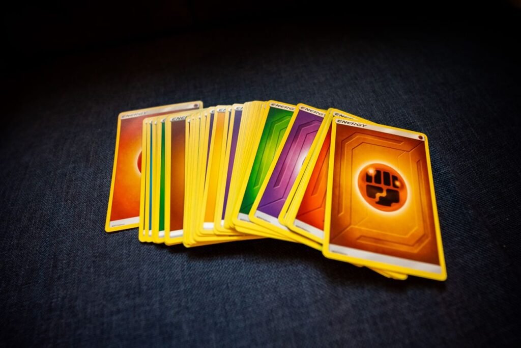 Overhead view of a stack of colorful collectible trading cards on a dark surface